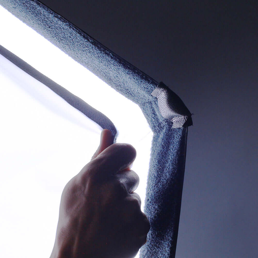 A close-up of a hand adjusting the Lightbank Octa 5 for Vortex8, showcasing its high-quality fabric and light diffusion.