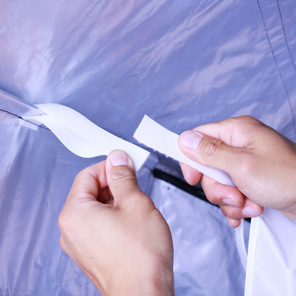 Hands adjusting the velcro straps of the Lightbank Octa 5 for Vortex8, ensuring secure attachment.