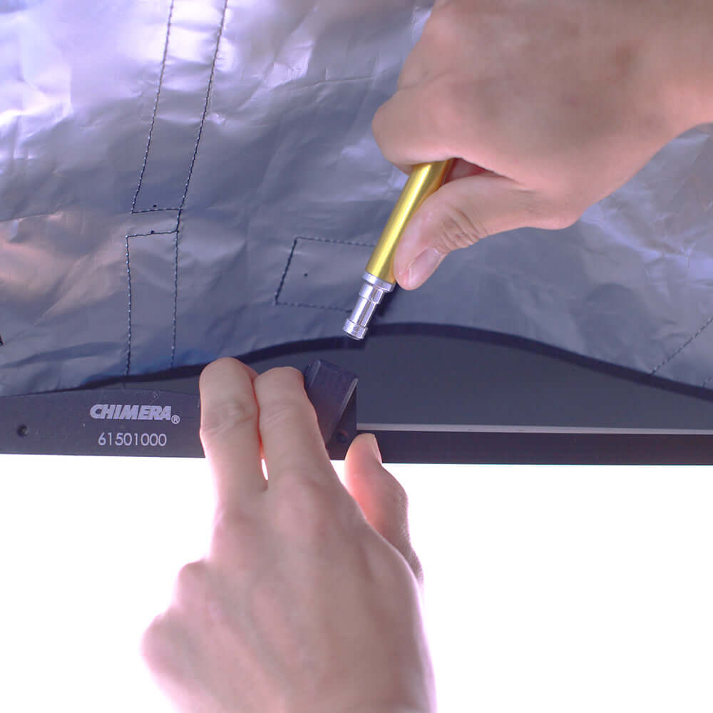 Hands adjusting the Lightbank Octa 5 for Vortex8, showcasing premium lighting setup for photography.